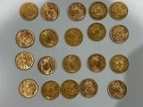 some gold coins are arranged in a circle on a white surface