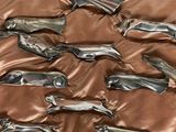 a lot of metal animals that are laying on a bed