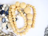 many beads and chains on a white surface