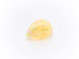 a yellow oplite stone with a white background