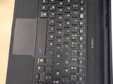 a black laptop computer sitting on a wooden desk