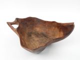 a close up of a wooden bowl on a white surface