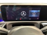 the steering wheel of a car with a display on the dashboard