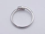 a close up of a diamond ring on a white surface