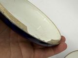 a hand that is holding a plate with a bowl on it