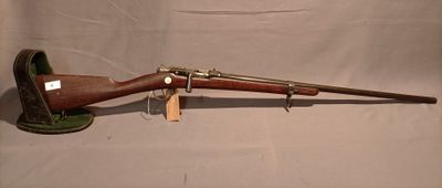 an old rifle with a wooden barrel and a wooden handle