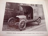 an old picture of a man sitting in the driver ' s seat of a car