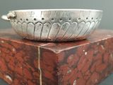 a silver bowl sitting on top of a red box