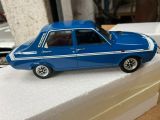 a blue toy car sitting on top of a white block