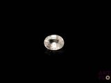 a close up of a white diamond on a black surface