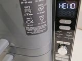a close up of a toaster with a digital clock on it