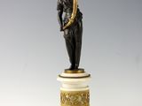 a statue of a woman holding a trumpet on a pedestal