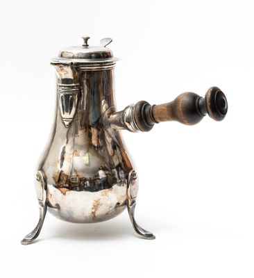 an antique silver coffee pot with a wooden handle on a white background