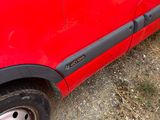 a red car that is parked on the side of the road