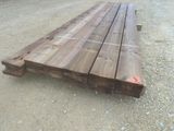 a pile of wood sitting on the ground in the dirt