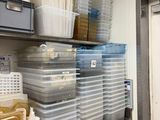 many plastic containers on the shelves in the room