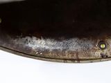 a close up of a pan with a handle on a table