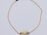 a gold bracelet with a heart charm on a chain