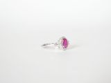 a pink sapphire and diamond ring on a white background