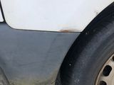 a white van with a flat tire on the street