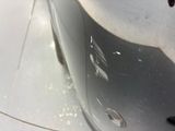 a close up of a car ' s front bumper with a hole in it