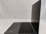 an open laptop computer sitting on top of a white table