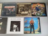 a lot of cd ' s that are on the table