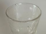 a glass cup that is sitting on a table