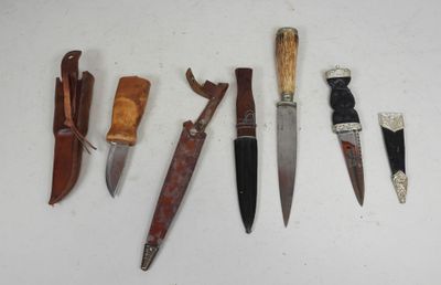 several different types of knives are lined up on a white surface
