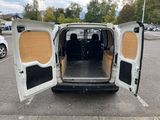 a white van with its doors open in a parking lot