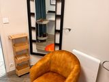 a chair and a mirror in the corner of a room