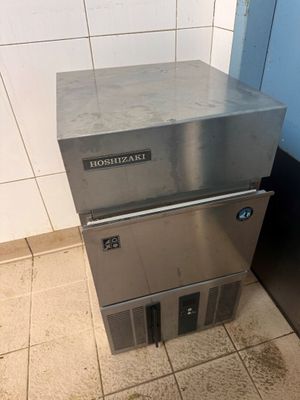 a stainless steel dishwasher sitting on top of a tiled floor