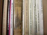 many books that are in a box on the shelf