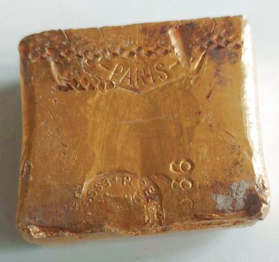 a close up of a soap bar on a white surface
