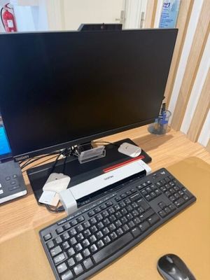 an image of a computer desk with a keyboard and a monitor
