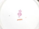 a white plate with a pink design on it