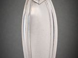 a silver vase on a table with a black background