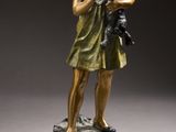 bronze statue of a young girl holding a cat on a pedestal