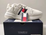 a box with a pair of white sneakers on top of it
