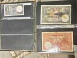 several different types of currency are displayed on a table