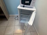 a microwave that is sitting on top of a shelf