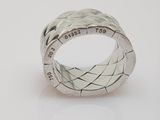 an image of a close up of a silver ring on a white surface