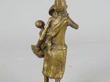 bronze figurine of a man holding a baby in his arms