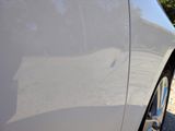 a close up of a car ' s door handle on the side of the road