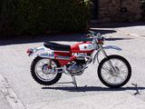 a small red and white motorcycle parked on the street