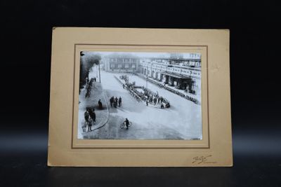 photograph of a black and white photo of a horse drawn carriage on a city street