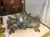 a silver plate with a clock on it on a table