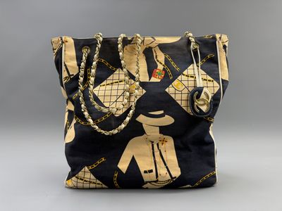 an image of a black and gold purse with chains on it