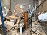 a pile of wood in a room with a brick wall