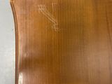 an image of a wooden chair in a room with a wall in the background